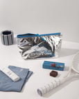 Sister's Aroma cosmetic bag in silver with blue accents, surrounded by fitness and beauty items.