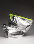 Sister's Aroma Cosmetic bags in shiny silver with neon zip, perfect for stylish beauty on the go.