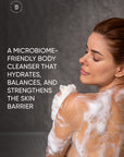 Woman with soapy skin against a dark background with promotional text about a microbiome-friendly body cleanser.
