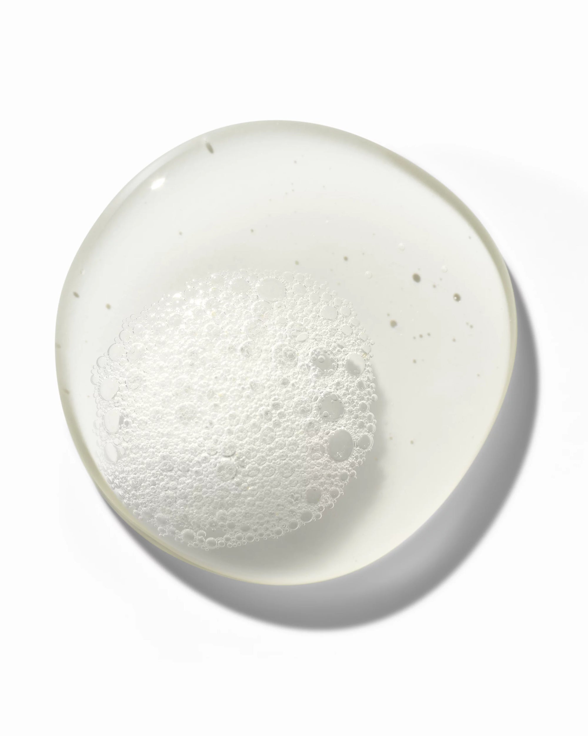 Transparent gel with bubbles representing deep cleansing properties of Authentic Beauty Concept shampoo.