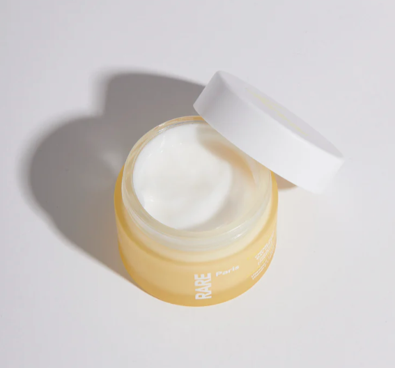 Rare Paris Trésor Solaire Day Cream jar with lid open, showcasing soothing cream for sensitive skin.