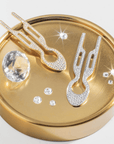 Fiona Franchimon Nº1 HAIRPIN Steel with Swarovski® Crystals | Yellow Gold Finish on a golden surface with crystals.