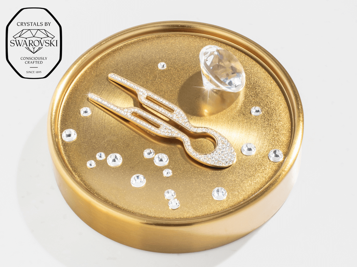 Fiona Franchimon Nº1 HAIRPIN Steel with Swarovski® Crystals | Yellow Gold Finish displayed on a gold circular base.