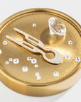 Fiona Franchimon Nº1 HAIRPIN Steel with Swarovski® Crystals | Yellow Gold Finish displayed on a gold circular base.