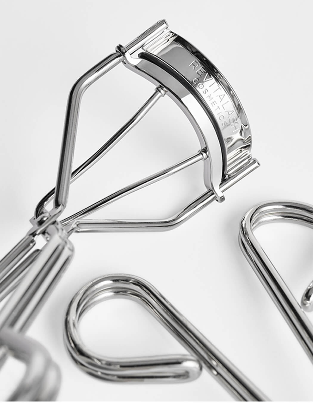 RevitaLash Signature Eyelash Curler Kleštičky na řasy detail view of chrome eyelash curler and its components