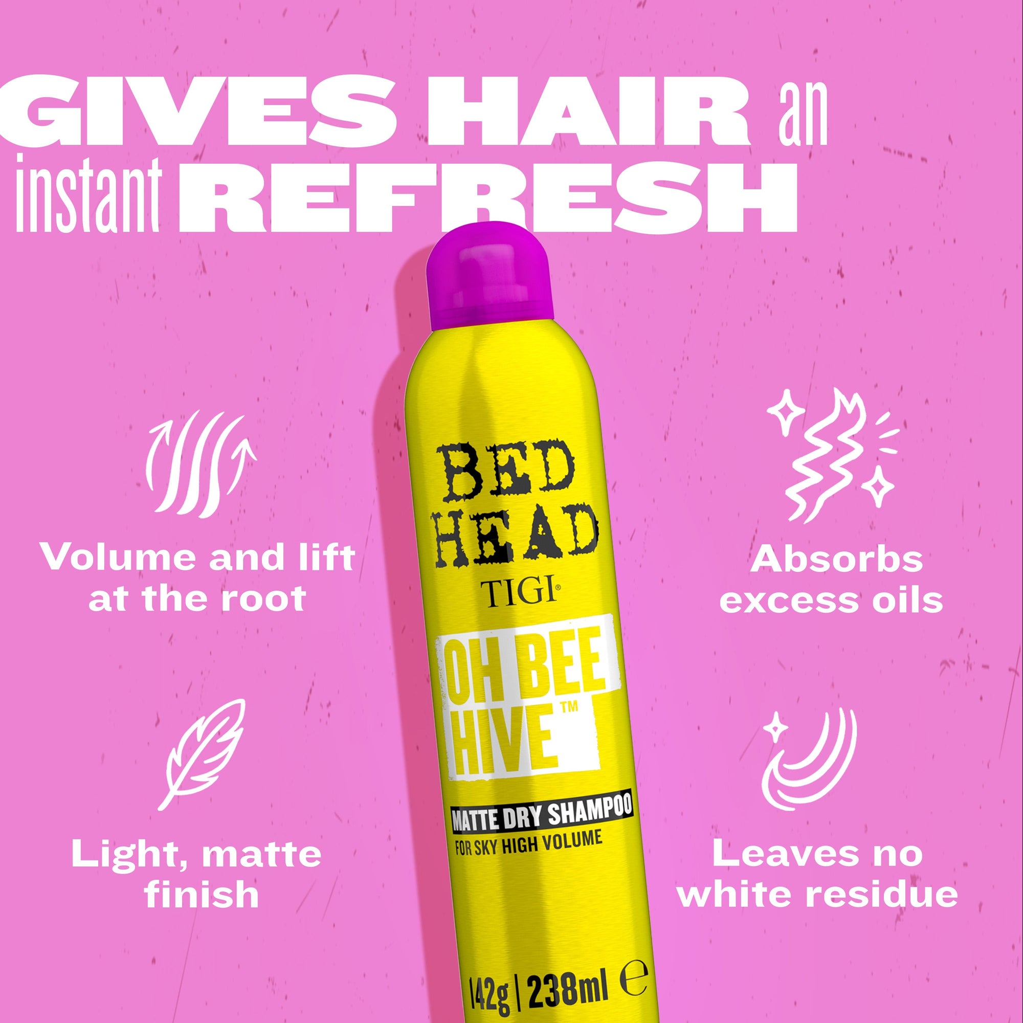Centered yellow BED HEAD dry shampoo bottle with purple cap and volume/absorb icons