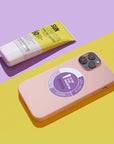 Instytutum Dark Spot Defence SPF50 sunscreen tube next to a pink smartphone with a skincare routine graphic